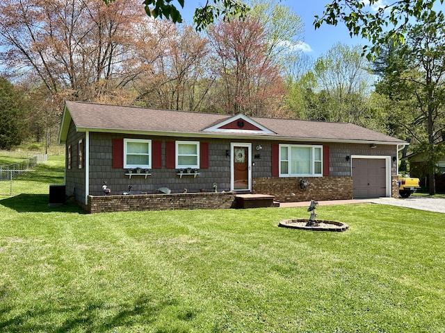 ranch-style house featuring an attached garage, driveway, fence, and a front lawn