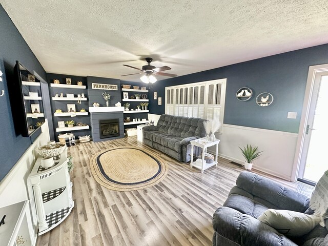 1870 Rush Branch Rd, Somerset, KY 42501 - living room with a textured ceiling, ceiling fan, a fireplace, and a wealth of natural light