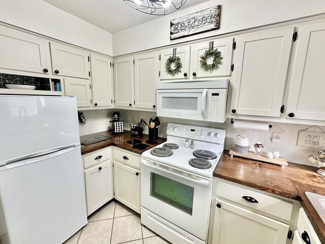 1870 Rush Branch Rd, Somerset, KY 42501 - kitchen with light tile patterned floors, white appliances, a textured ceiling, white cabinetry, and dark countertops