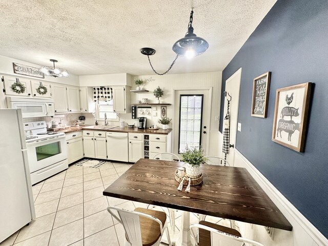 1870 Rush Branch Rd, Somerset, KY 42501 - kitchen featuring a sink, light tile patterned floors, white appliances, and a healthy amount of sunlight