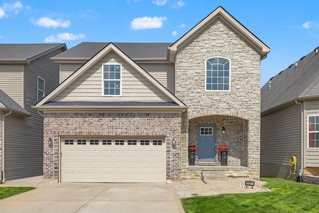 craftsman-style house featuring a front yard, stone siding, concrete driveway, brick siding, and roof with shingles