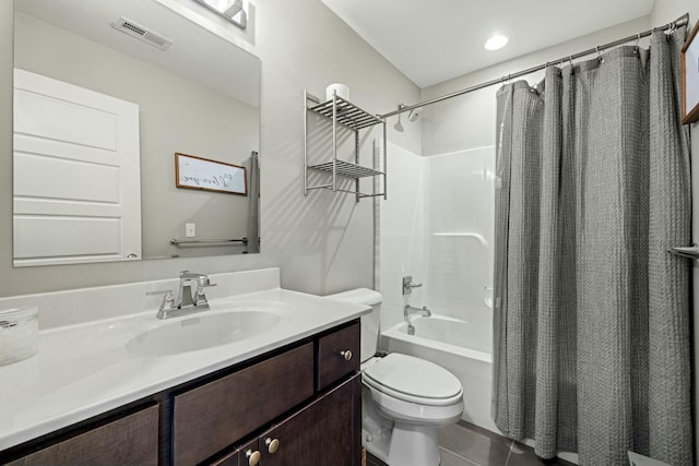 bathroom with vanity, visible vents, toilet, shower / tub combo with curtain, and tile patterned floors