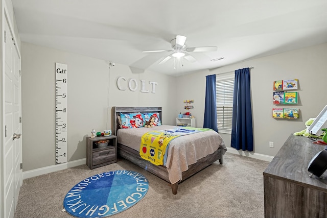 carpeted bedroom with visible vents, baseboards, and a ceiling fan