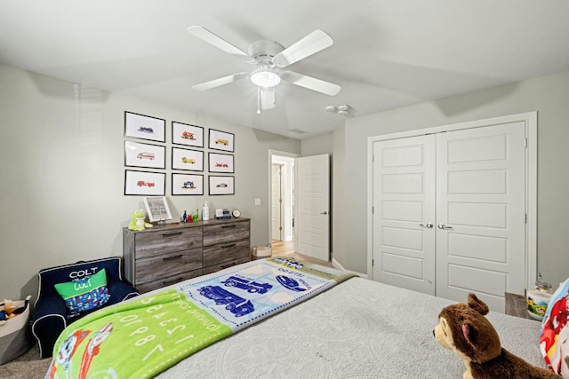 bedroom with a closet, baseboards, and a ceiling fan