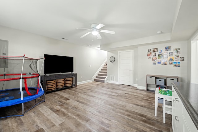game room featuring wood finished floors, ceiling fan, baseboards, and visible vents