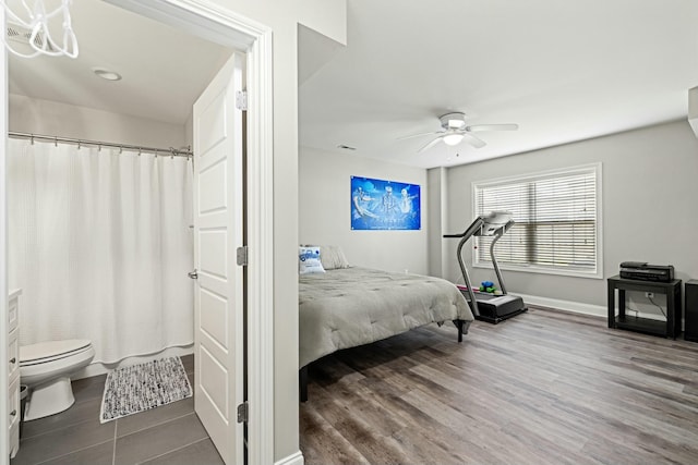 bedroom with baseboards, a ceiling fan, and wood finished floors