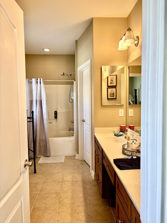 full bath with tile patterned floors, double vanity, a sink, and tub / shower combination