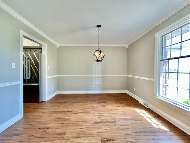 unfurnished dining area with crown molding, a wealth of natural light, light wood finished floors, and baseboards