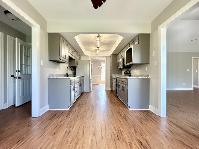 kitchen featuring gray cabinets, ceiling fan, and appliances with stainless steel finishes
