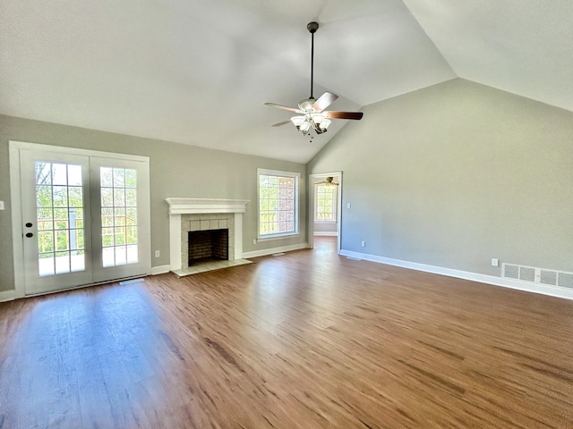 unfurnished living room featuring plenty of natural light, visible vents, a ceiling fan, and lofted ceiling