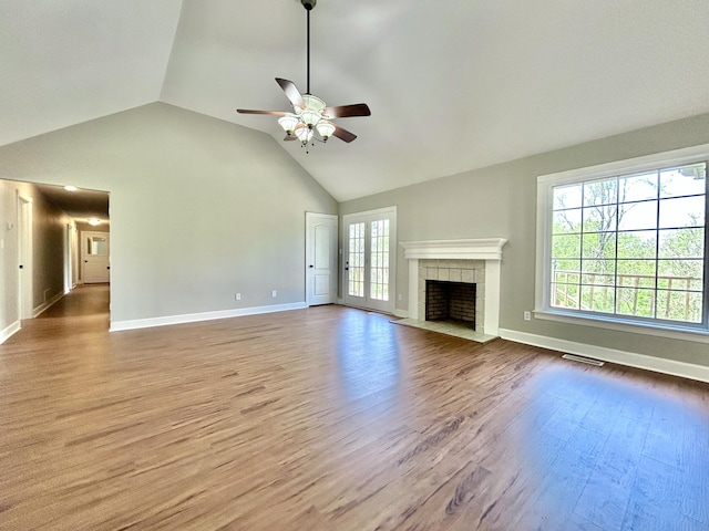 unfurnished living room featuring visible vents, baseboards, a ceiling fan, and wood finished floors