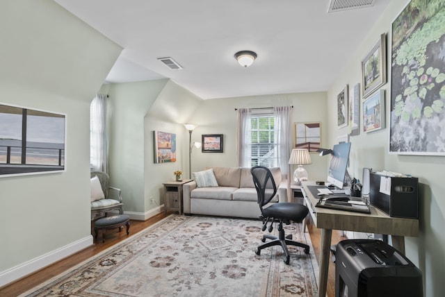office area featuring visible vents, wood finished floors, and baseboards