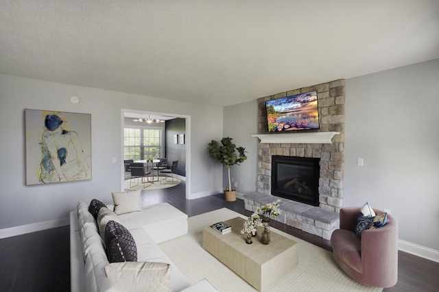2045 Kearns Way, Richmond, KY 40475 - living room with dark wood-type flooring, a stone fireplace, baseboards, and a chandelier