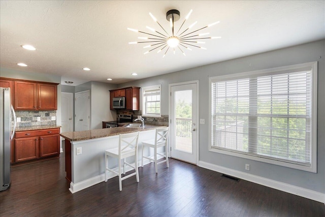 2045 Kearns Way, Richmond, KY 40475 - kitchen with stainless steel appliances, tasteful backsplash, a peninsula, dark wood-type flooring, and baseboards