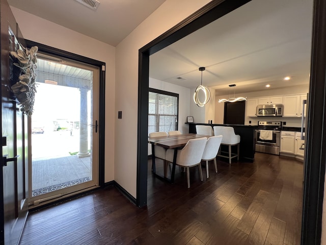dining area featuring recessed lighting, dark wood finished floors, baseboards, and visible vents