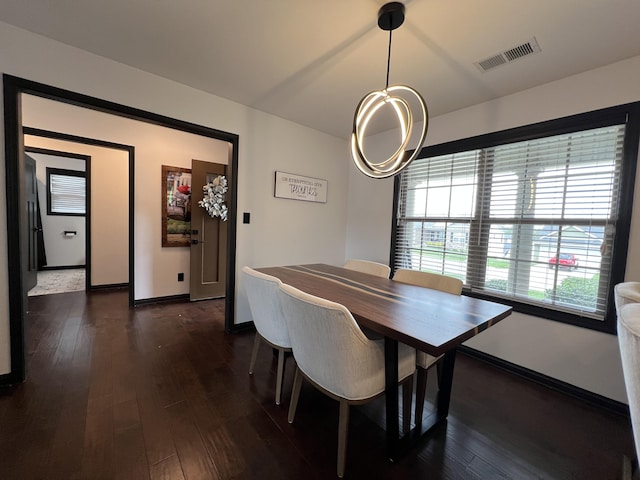 dining space featuring visible vents, baseboards, and dark wood-type flooring