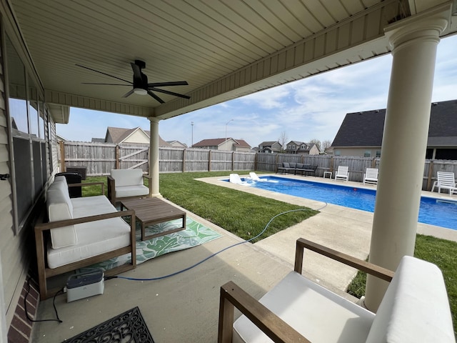 view of patio / terrace with ceiling fan, a residential view, a fenced in pool, an outdoor hangout area, and a fenced backyard