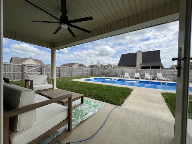 view of patio / terrace with a fenced in pool, a ceiling fan, and a fenced backyard