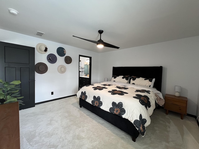 carpeted bedroom with visible vents, a ceiling fan, baseboards, and ensuite bathroom