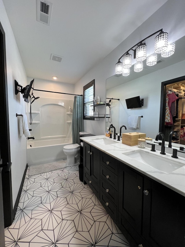 bathroom with visible vents, a sink, shower / bath combo with shower curtain, and toilet