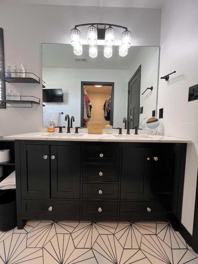 bathroom featuring visible vents, a sink, and double vanity