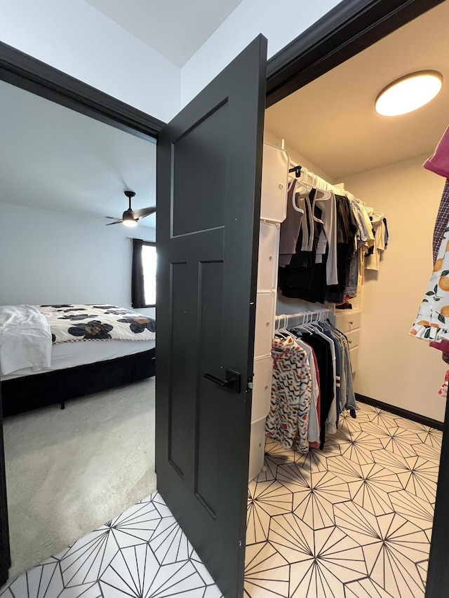 walk in closet featuring light carpet and light tile patterned flooring