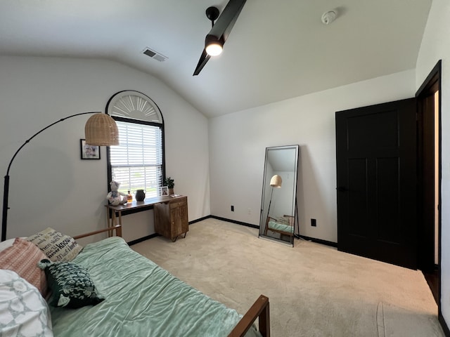 bedroom with ceiling fan, light colored carpet, visible vents, baseboards, and vaulted ceiling