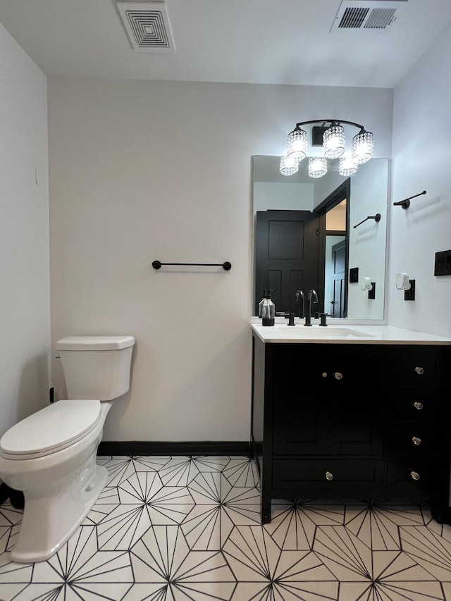 bathroom featuring visible vents, tile patterned floors, toilet, and vanity
