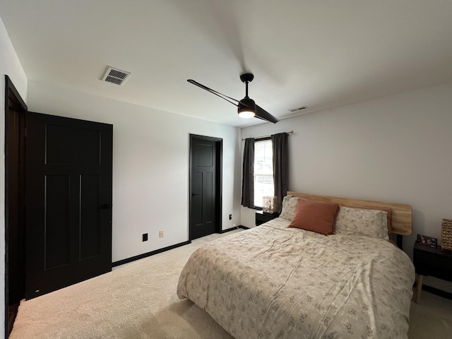 bedroom with light colored carpet, ceiling fan, visible vents, and baseboards