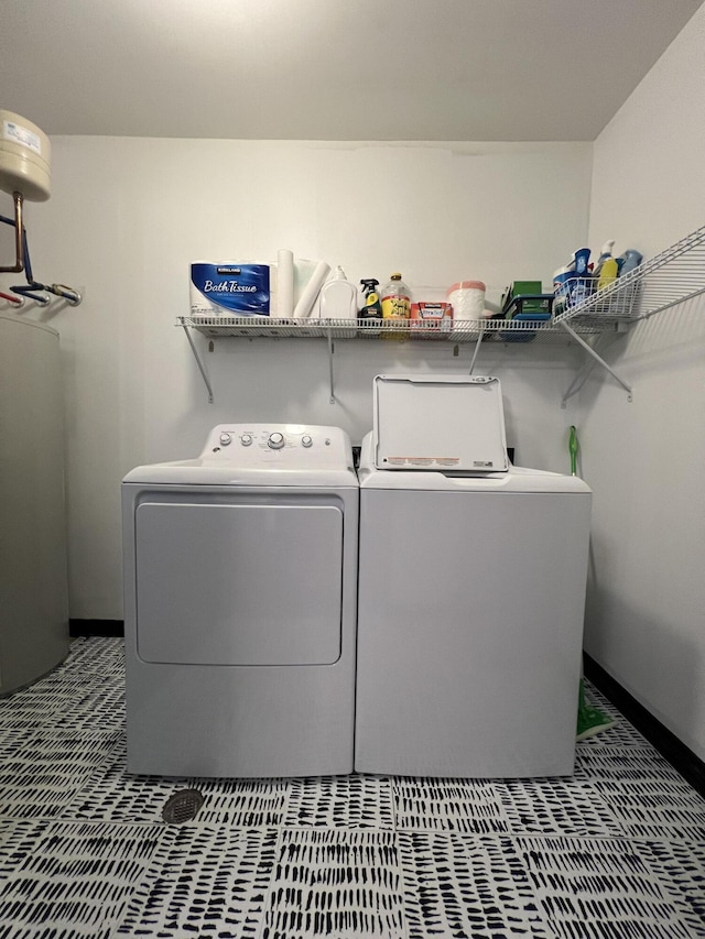 laundry area featuring laundry area, water heater, and separate washer and dryer