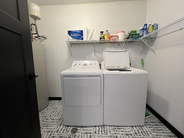 washroom with independent washer and dryer, laundry area, baseboards, and tile patterned flooring