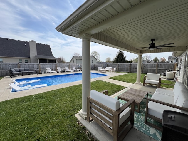 view of pool featuring a yard, a fenced backyard, an outdoor hangout area, and a patio area