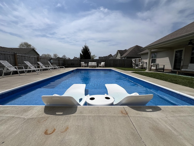view of swimming pool with a fenced in pool, a fenced backyard, and a patio area