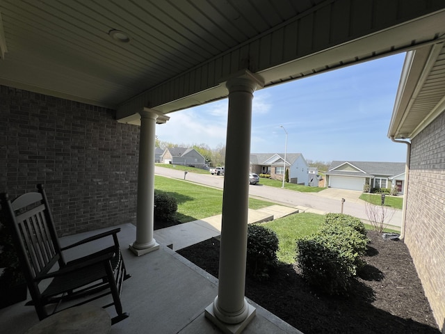 view of patio featuring covered porch and a residential view