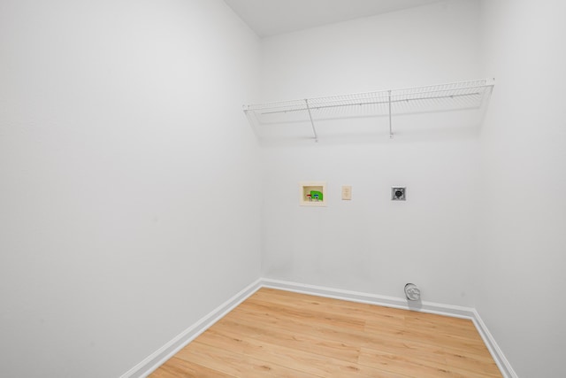 laundry area with hookup for an electric dryer, laundry area, light wood-type flooring, and hookup for a washing machine