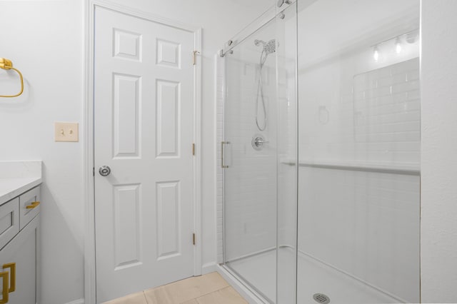 full bathroom featuring a shower stall, tile patterned flooring, and vanity