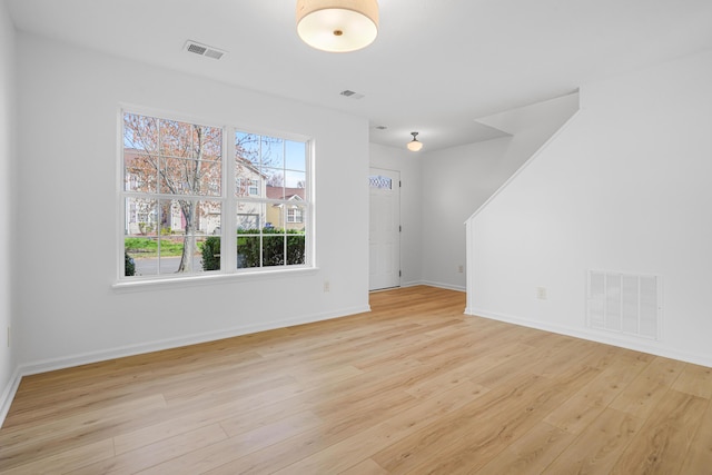 unfurnished living room featuring baseboards, light wood-style flooring, and visible vents