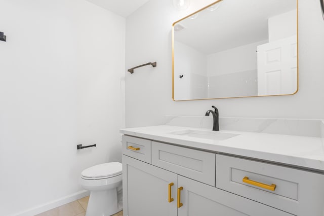 bathroom featuring toilet, baseboards, tile patterned flooring, and vanity