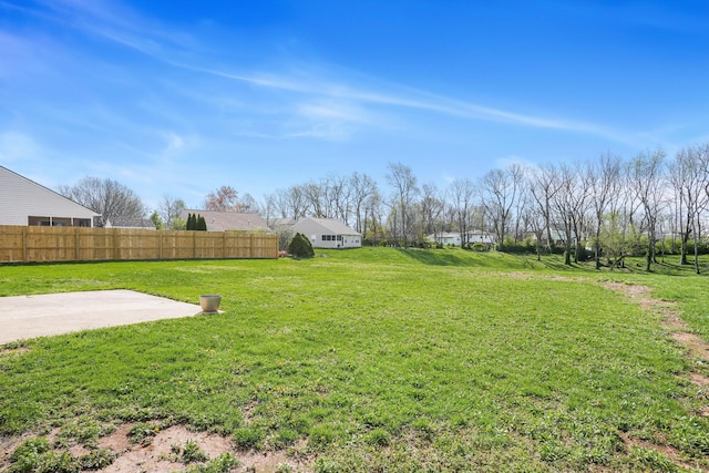 view of yard featuring fence and a patio