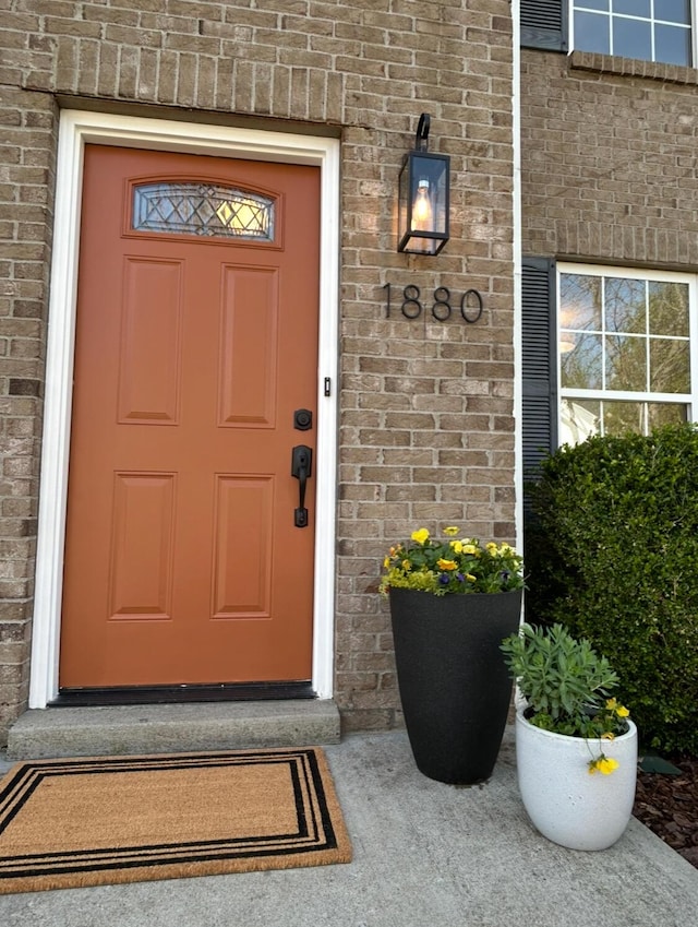 property entrance featuring brick siding