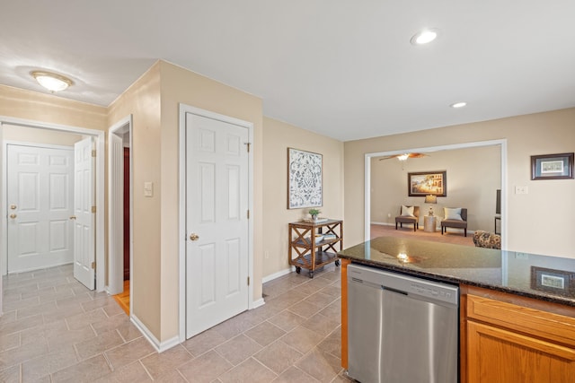 kitchen featuring stainless steel dishwasher, dark stone counters, light tile patterned flooring, baseboards, and recessed lighting
