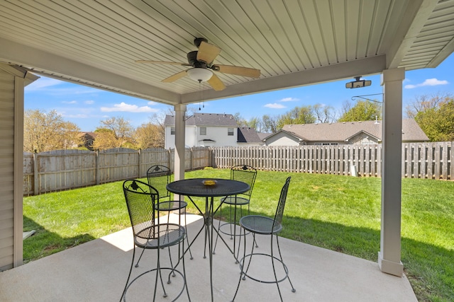 view of patio with a ceiling fan, outdoor dining space, and a fenced backyard