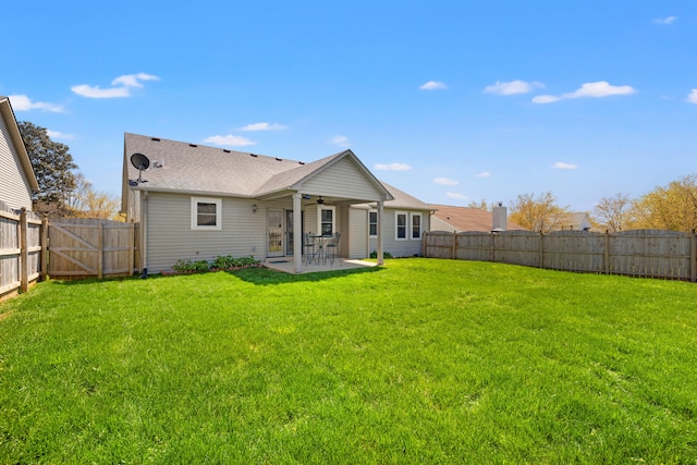back of house featuring a fenced backyard, a yard, a patio area, and ceiling fan