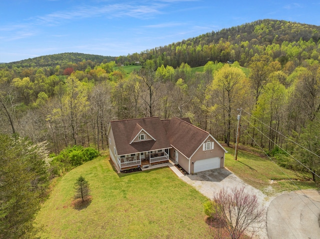 drone / aerial view with a wooded view