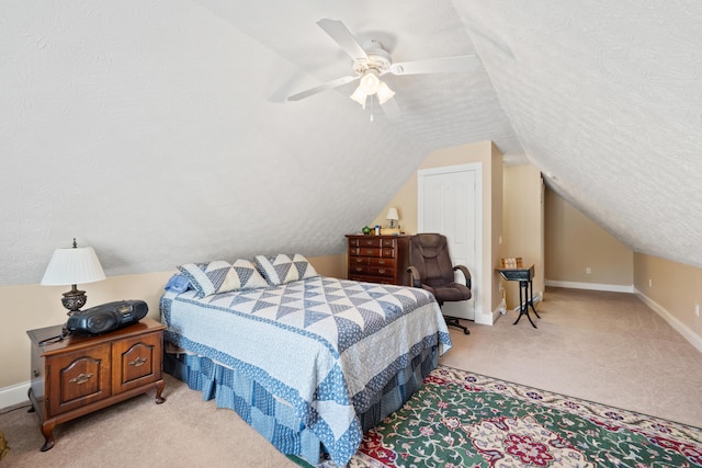 carpeted bedroom with baseboards, a ceiling fan, and lofted ceiling