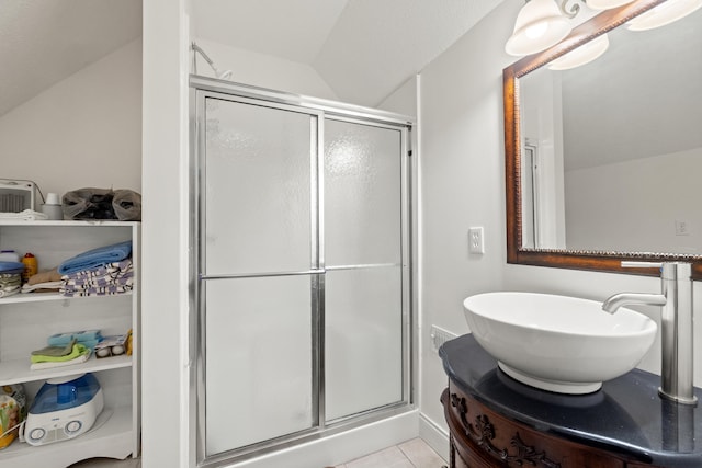 full bath with tile patterned flooring, a stall shower, and vanity
