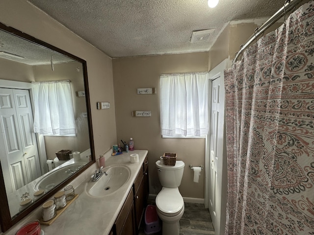 full bathroom featuring visible vents, toilet, a textured ceiling, vanity, and wood finished floors