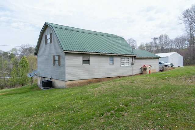 back of house with a yard, metal roof, central air condition unit, and a gambrel roof