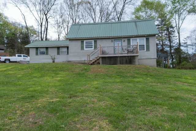 view of front of property with a front yard, stairway, metal roof, and a wooden deck