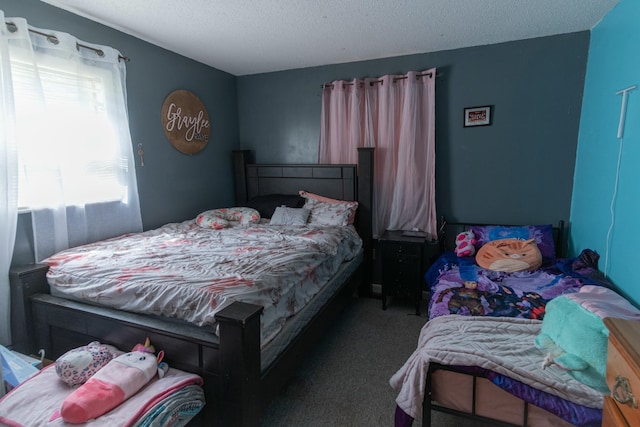 carpeted bedroom with a textured ceiling